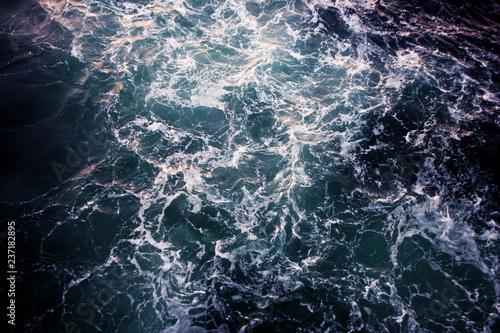 Ocean view from the top. Blue-green waves, storm, sea surface.