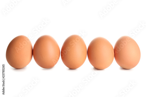 Raw brown chicken eggs on white background