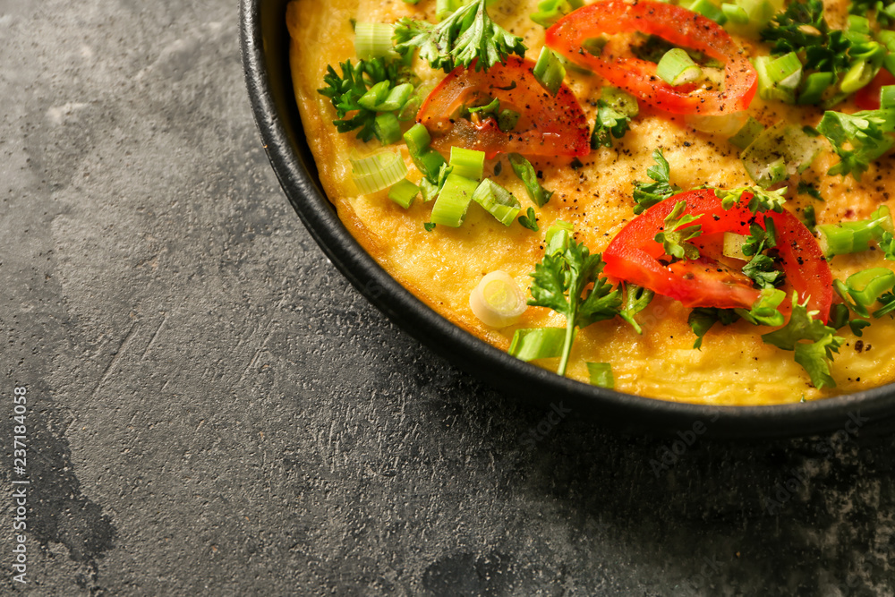Pan with tasty omelet on grey table, closeup Pan with tasty omelet on grey table, closeup