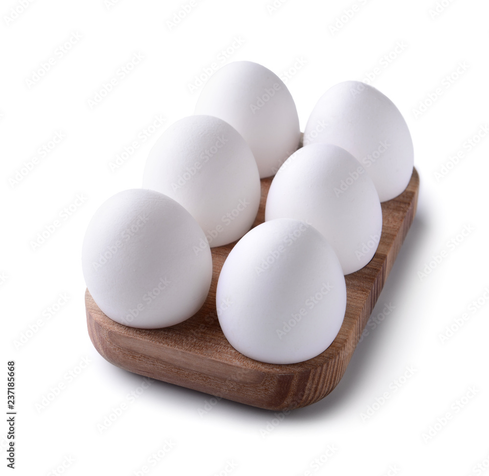 Wooden holder with chicken eggs on white background Wooden holder with chicken eggs on white background