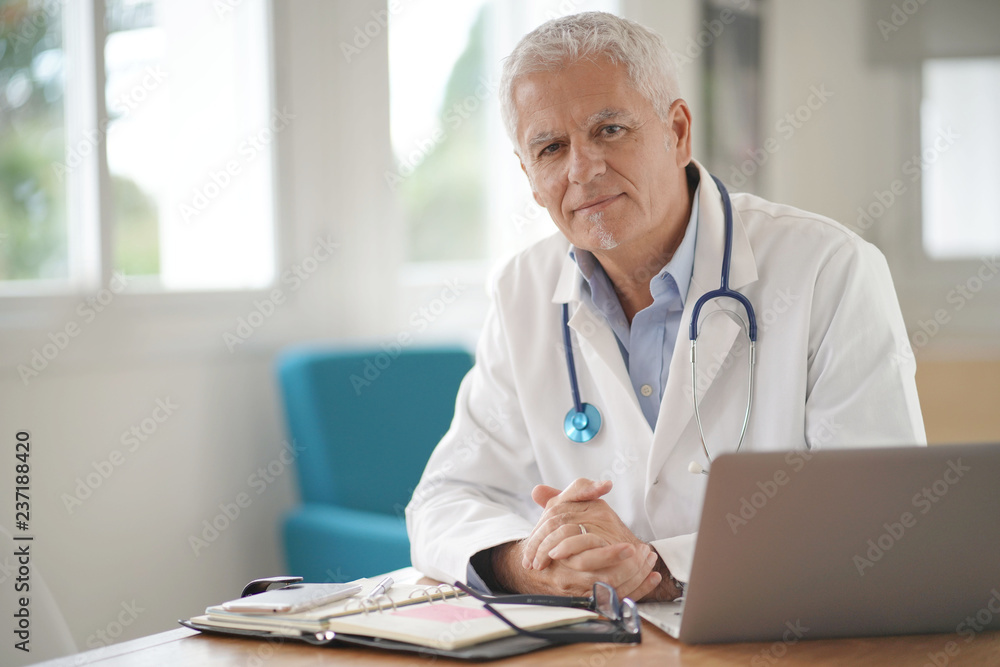 Portrait of smiling mature doctor at work Portrait of smiling mature doctor at work