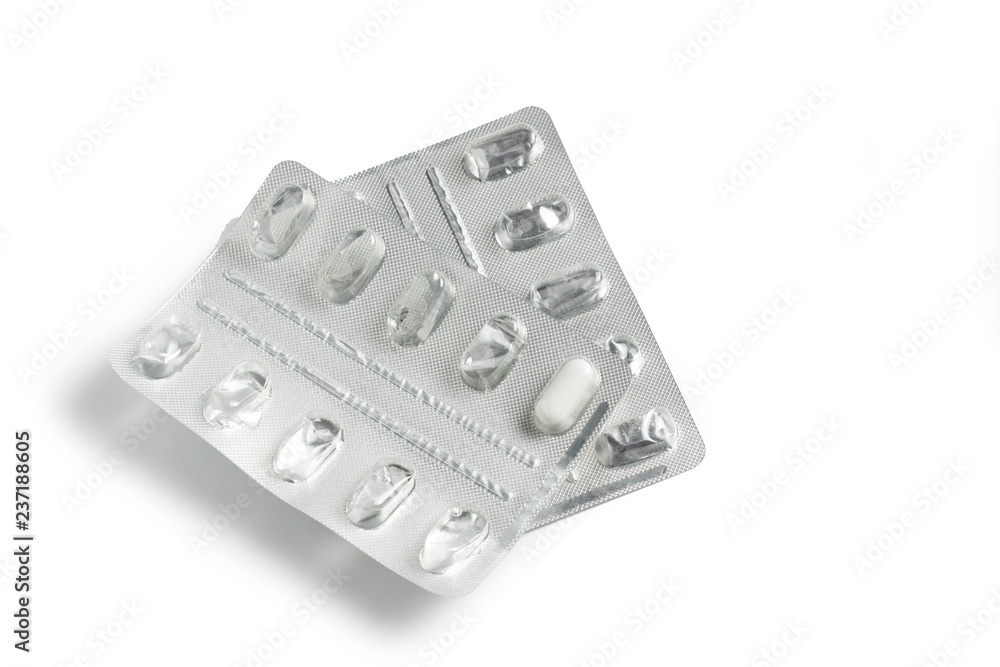 Close-up of empty pill package isolated on white background. Used blister tablet. A package of empty plastic foil, which was used to store drugs and medicines that were used by a sick patient to treat Close-up of empty pill package isolated on white background. Used blister tablet. A package of empty plastic foil, which was used to store drugs and medicines that were used by a sick patient to treat