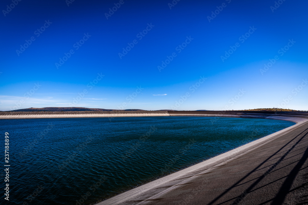 Scenic photo of the upper water reservoire Dlouhe Strane in the Jeseniky mountains in Czech Republic with dark blue sky and waves on the water