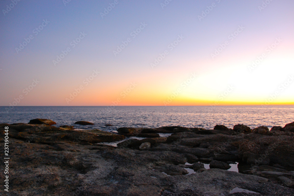 Beautiful sunset on the sea. Smooth lines of the horizon. Natural background.