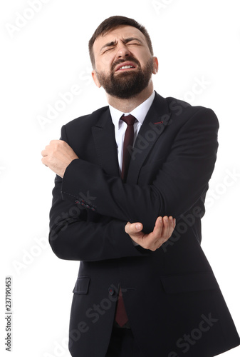 Businessman suffering from pain in elbow on white background