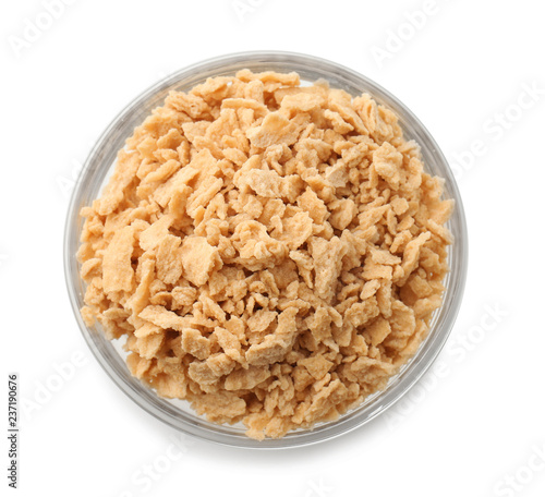 Bowl with maple sugar flakes on white background