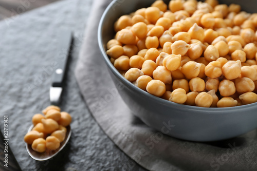 Bowl with chickpeas on table