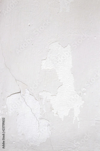 Light wall with white paint peeling off texture in grey and white tone. Copy space. Background for design. © Struzhkova Ilona