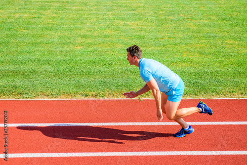 Man athlete runner push off starting position stadium path sunny day. Runner sprint race at stadium. Runner captured in motion just after start of race. How to start running. Boost speed concept © be free