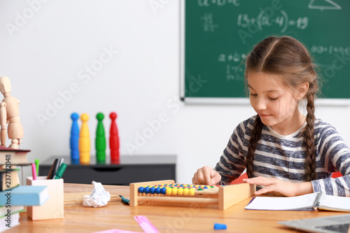 Cute girl doing homework in...