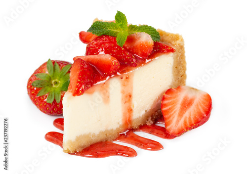 Piece of cheesecake with fresh strawberries and mint