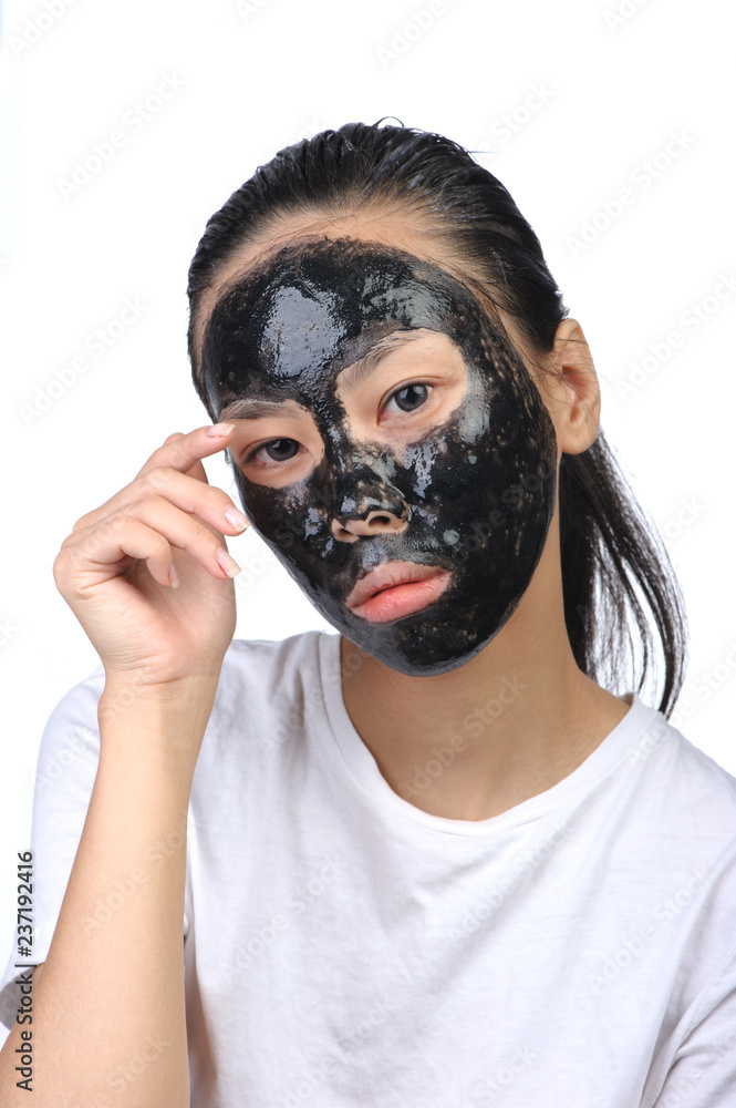 Asian woman with black spa mask Asian woman with black spa mask