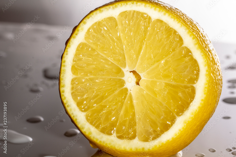 lemon slice On white plastic surfaces, covered with drops of water lemon slice On white plastic surfaces, covered with drops of water