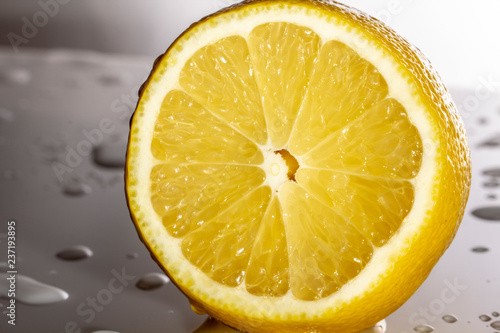 lemon slice On white plastic surfaces, covered with drops of water