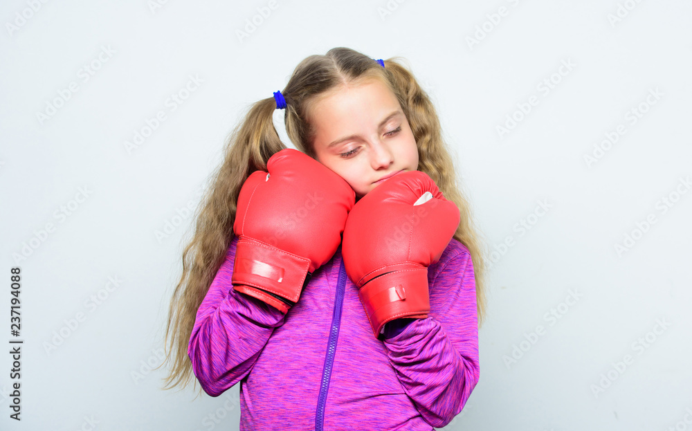Girl cute child with red gloves posing on white background. Upbringing for leader. Strong child boxing. Sport and health concept. Boxing sport for female. Skill of successful leader. Sport upbringing Girl cute child with red gloves posing on white background. Upbringing for leader. Strong child boxing. Sport and health concept. Boxing sport for female. Skill of successful leader. Sport upbringing