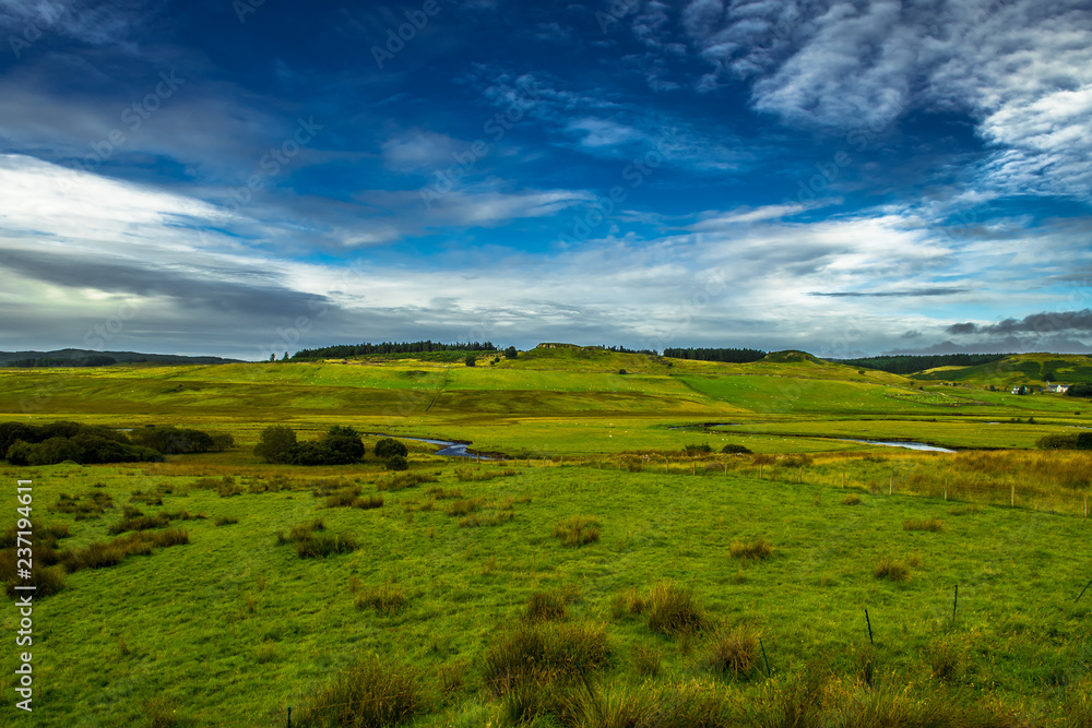 Scenic Landscape With Small River And Pastures With Flocks Of Sheep On The Isle Of Skye In Scotland