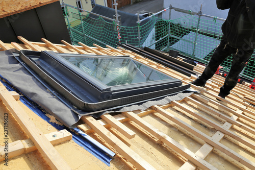 Roofer installing a skylight photo