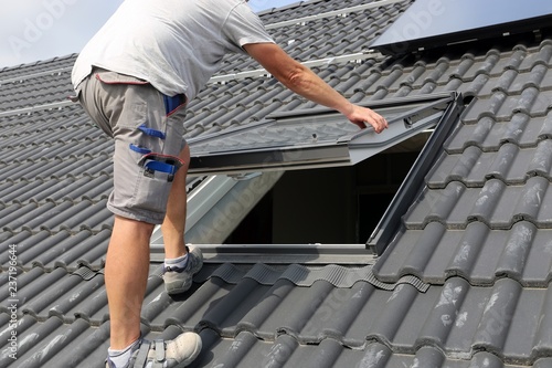 Photos Roofer installing a skylight