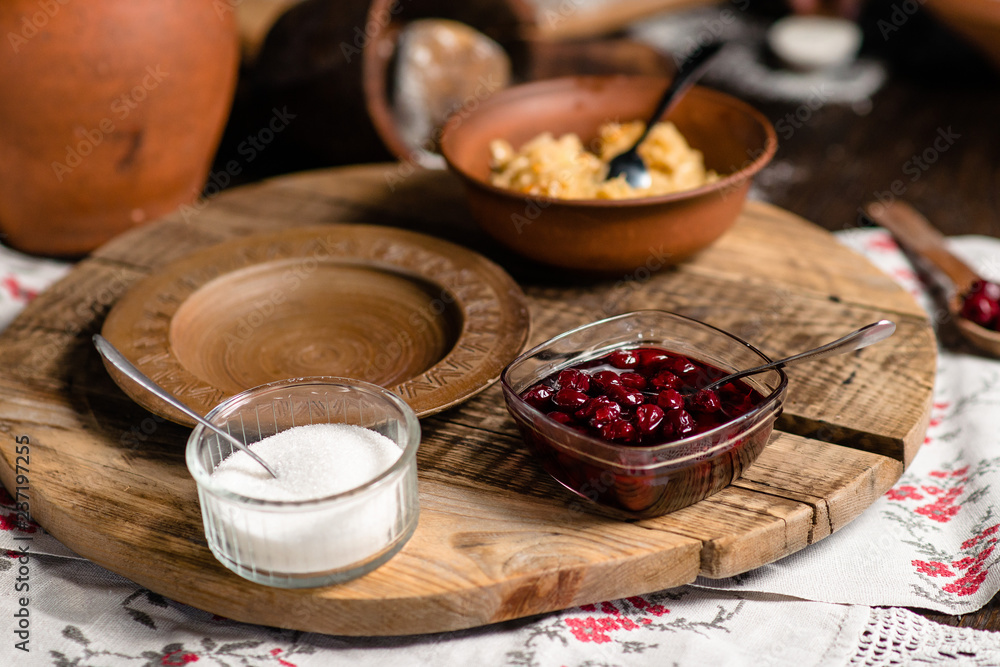 cherry jam in a vase on a wooden background cherry jam in a vase on a wooden background