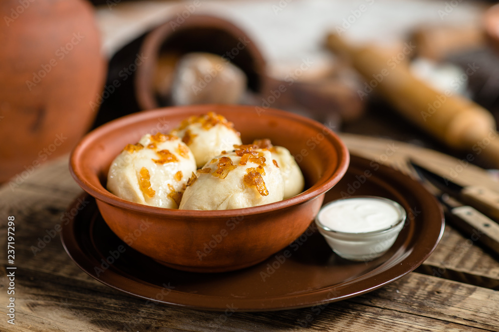 dumplings in a clay bowl on a wooden board dumplings in a clay bowl on a wooden board