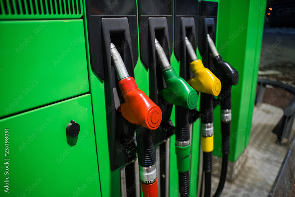 Fueling nozzles in different colors on green bright station