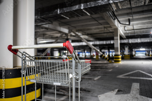 Chrome store trolley at underground parking with illuminated background