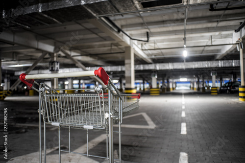 Chrome store trolley at underground parking with illuminated background