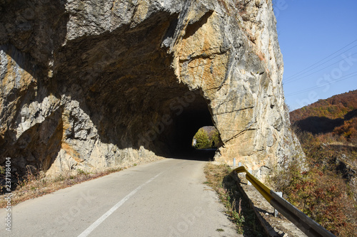 Old rural road with handmade tunnels.
Curvy road through tunnel in canyon of river Jerma photo