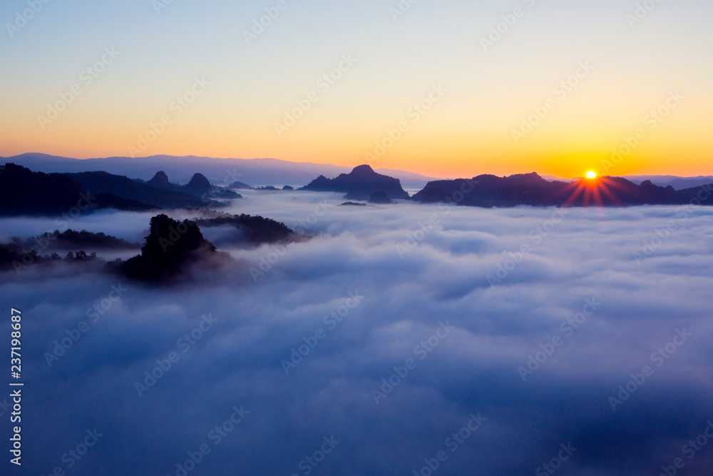 Morning sunrise over mist .