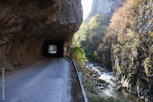 Old rural road with handmade tunnels.
Curvy road through tunnel in canyon of river Jerma