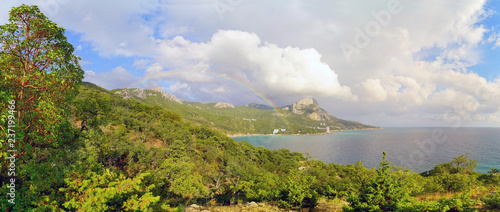 Black sea landscape with a beautiful rainbow above the Bay of Laspi . Crimea. Panorama.