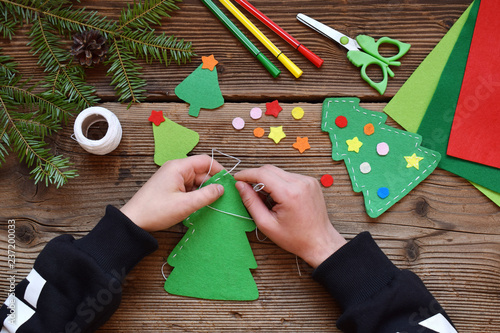 Making of handmade christmas tree from felt with your own hands. Children's DIY concept. Making xmas toys decoration or greeting card. photo