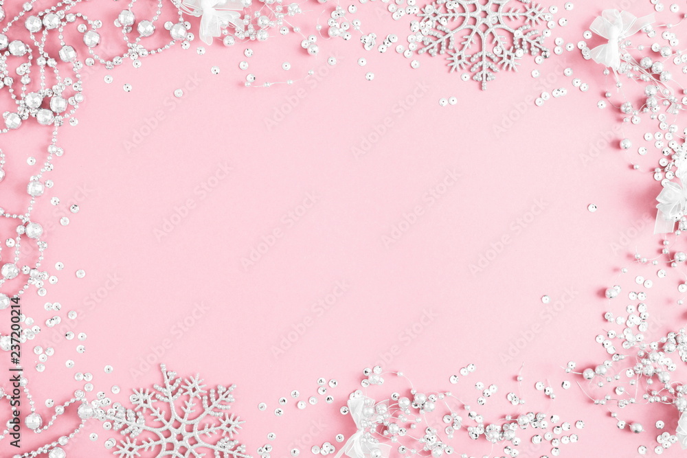 Christmas elegant modern composition. Xmas silver decorations on pastel pink background. Christmas, New Year, winter concept. Flat lay, top view, copy space