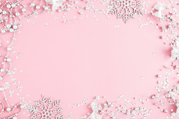 Christmas elegant modern composition. Xmas silver decorations on pastel pink background. Christmas, New Year, winter concept. Flat lay, top view, copy space