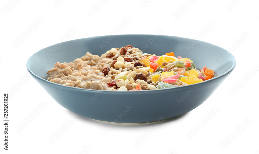 Plate with tasty oatmeal, nuts and succades on white background Plate with tasty oatmeal, nuts and succades on white background