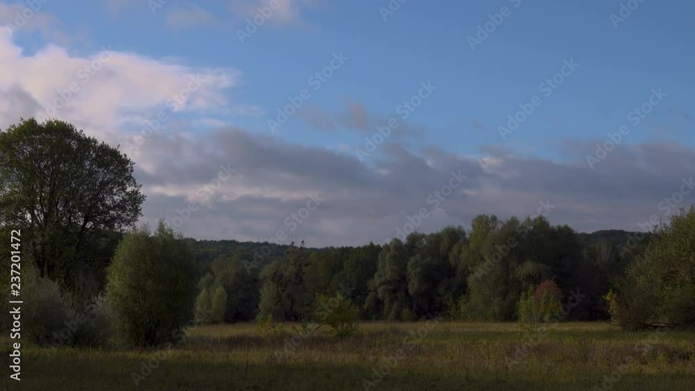 wind drives the clouds over the top of the trees in the hilly terrain. wind drives the clouds over the top of the trees in the hilly terrain.