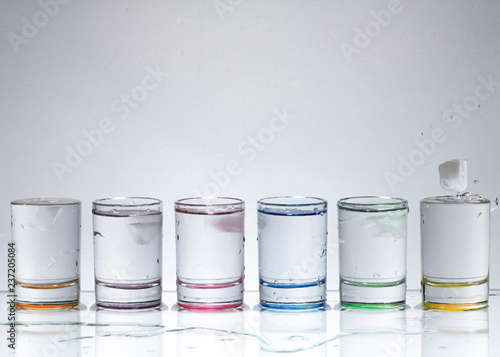 Water droplets from dropping an ice cube into a glass of liquid.