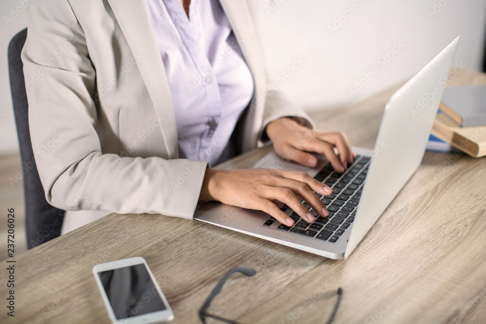 Young woman working with laptop in office