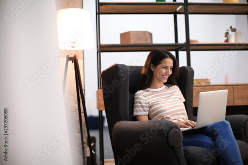 Young woman working with laptop at home