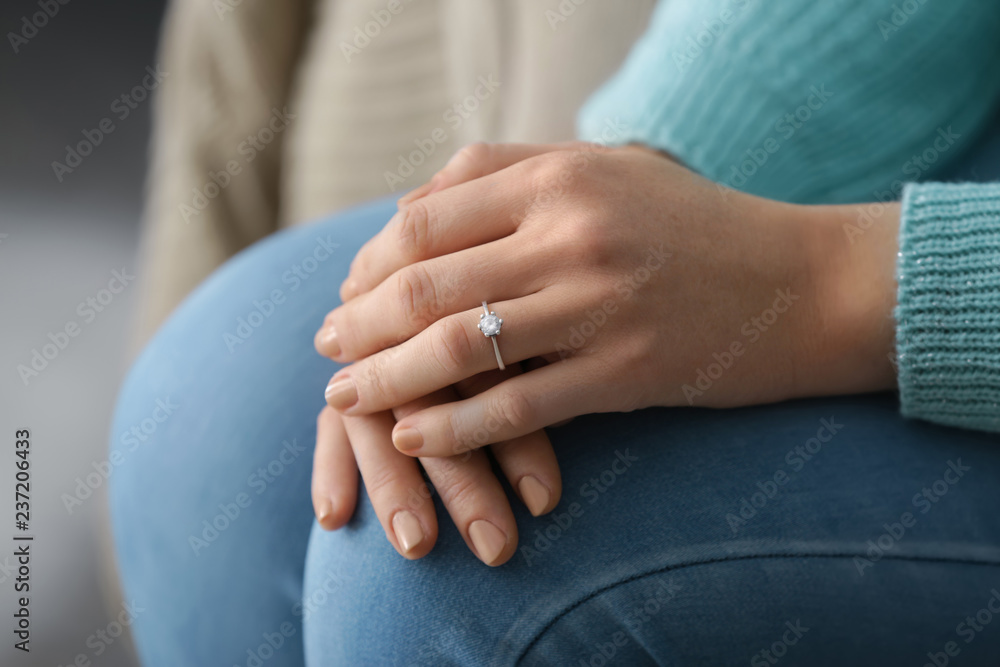 Young woman with engagement ring on her finger, closeup