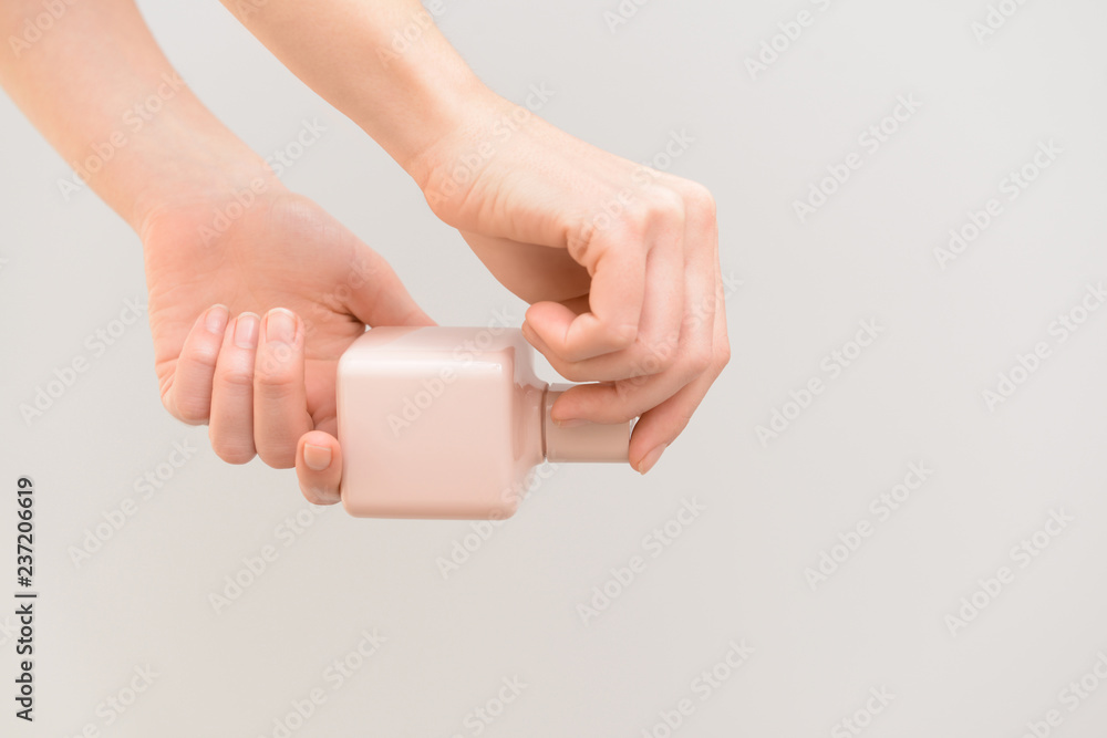 Woman holding bottle of perfume on color background Woman holding bottle of perfume on color background