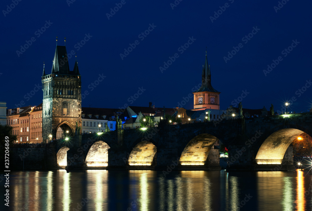 Naklejka premium City landscape, Prague, Czech Republic. Buildings and structures over the river in the evening, summer. Ancient European city