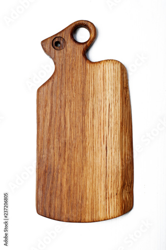 Oak cutting board on a white background. The handle of the board is stylized under the head of a ram or mouse.