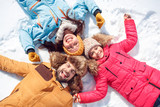 Winter vacation. Family time together outdoors lying smiling happy top view close-up