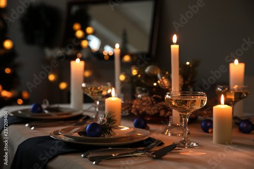 Burning candles on beautiful  table setting for Christmas dinner