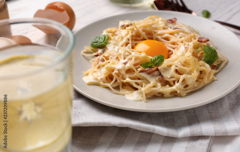 Plate with delicious pasta carbonara on table Plate with delicious pasta carbonara on table
