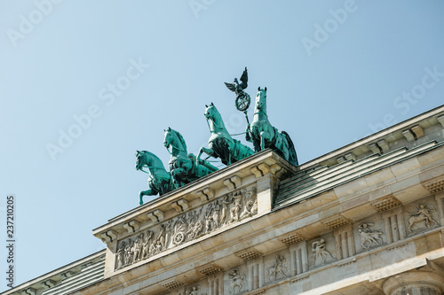 Closeup of the Brandenburg Gate against the blue sky. This is one of the attractions of Berlin in Germany.