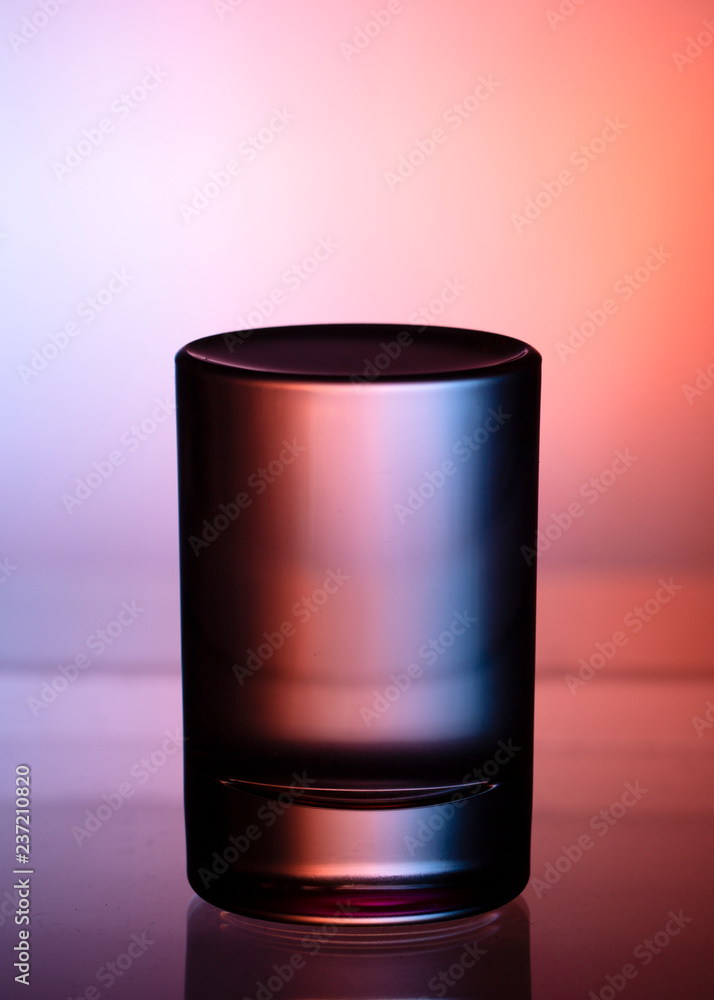 Glass with water on a dark colorful background Glass with water on a dark colorful background