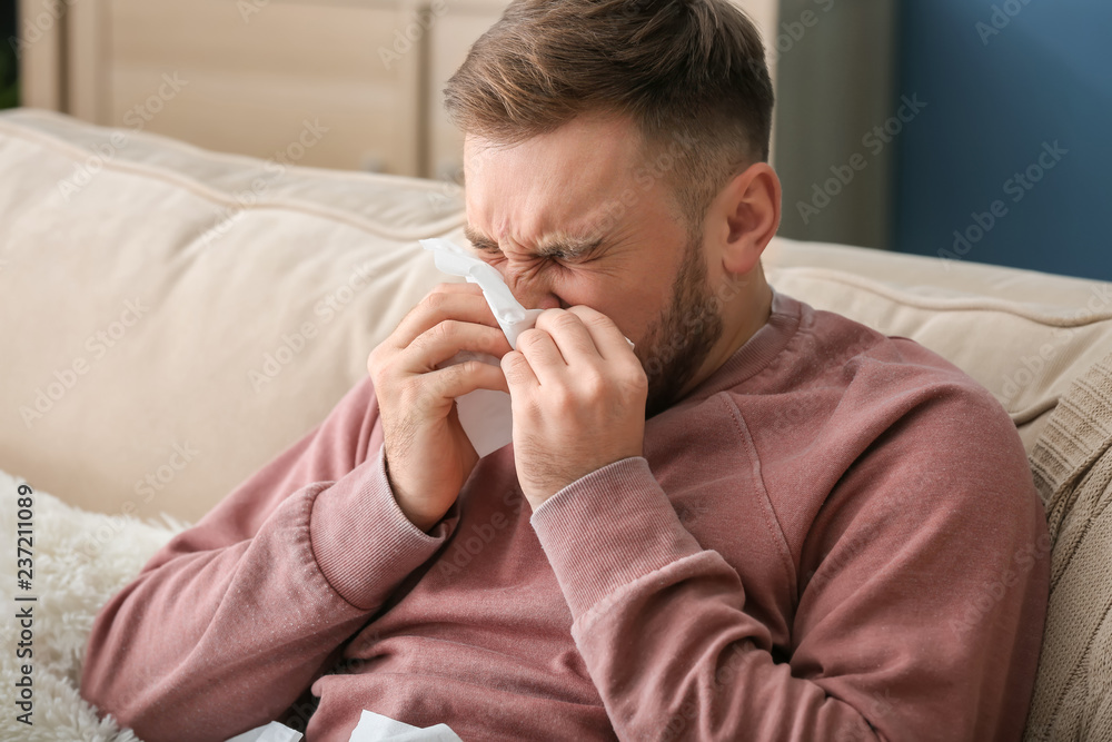 Young man ill with flu at home Young man ill with flu at home