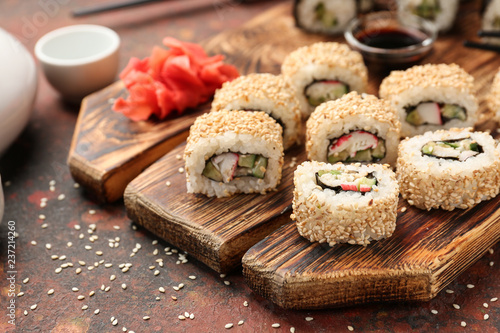 Tasty sushi on wooden board